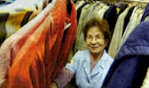 Foto: Seniorin zwischen den Kleiderständern der Kleiderkammer.
